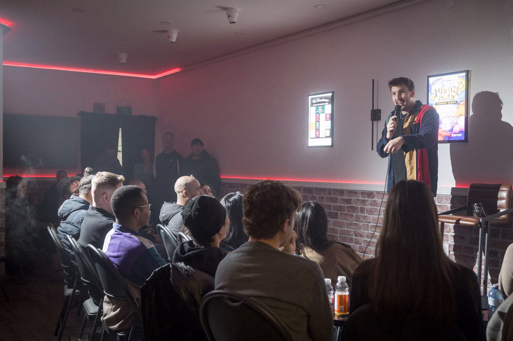 Comedian on stage at The Boardroom Comedy Club in Toronto